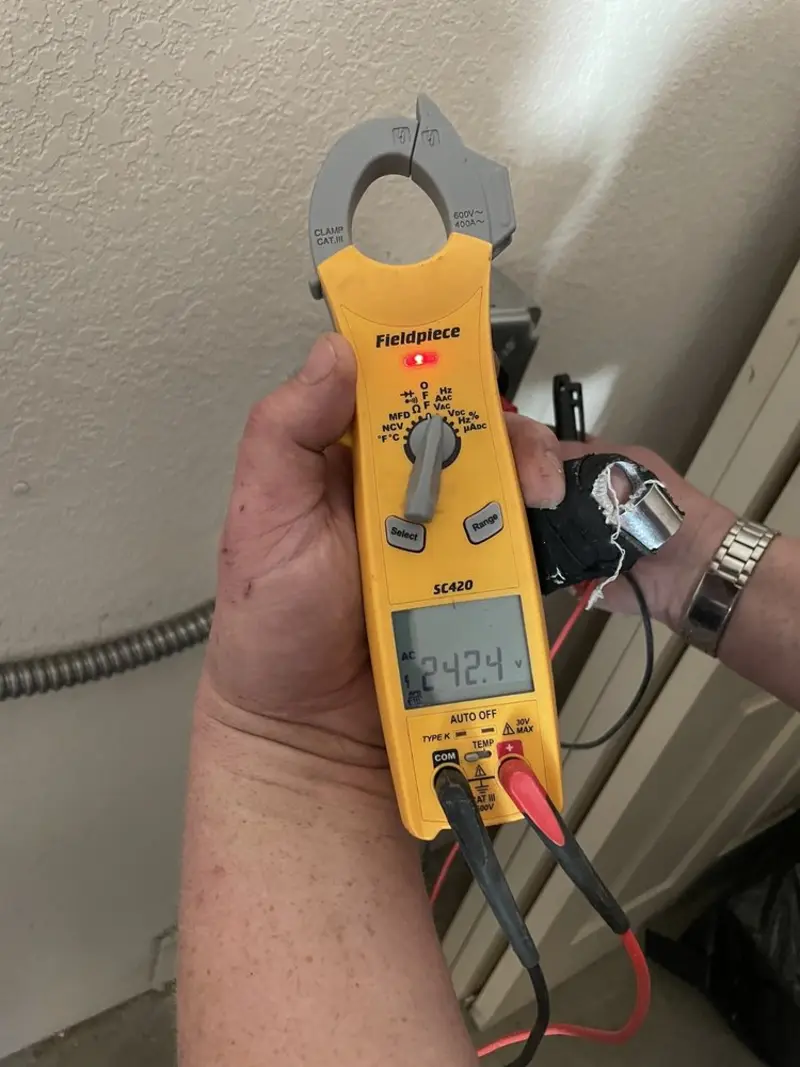 Voltage testing with clamp meter during Whole House Surge Protector in Seagoville